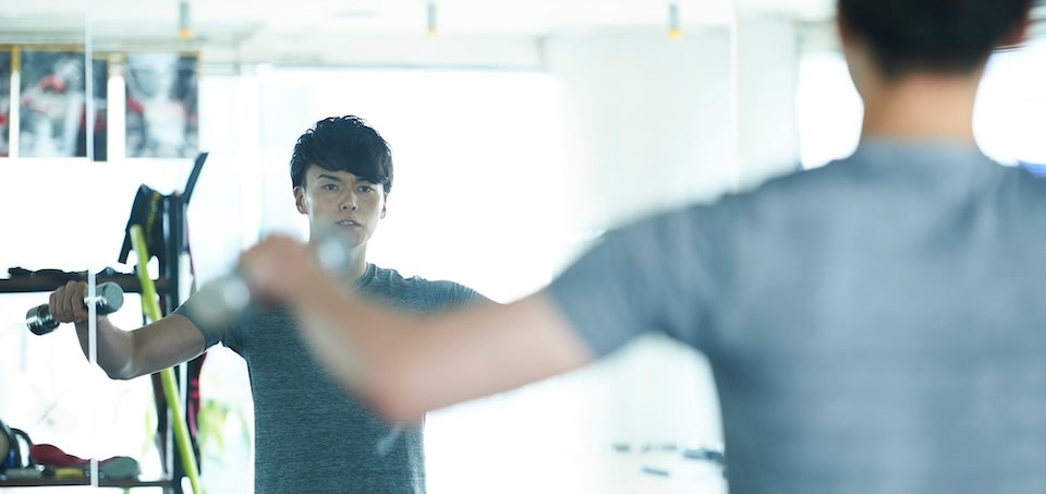 ダンベルでトレーニングする男性